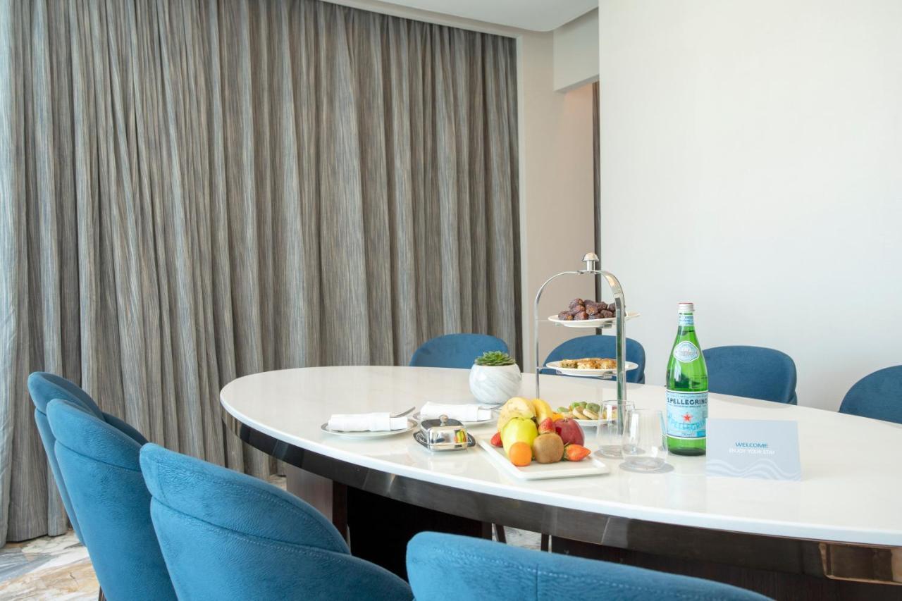 Century Marina Hotel - Lusail Esterno foto A table with a bottle of mineral water